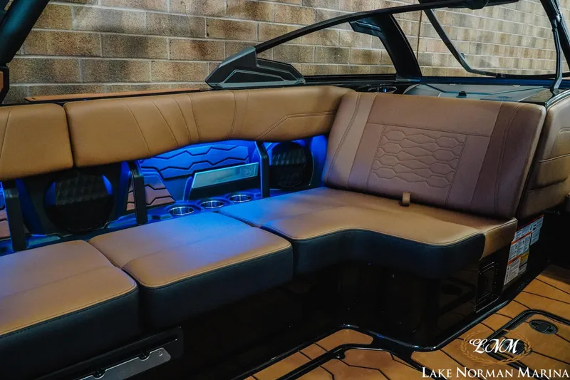 Slide: The Image of 2026 Malibu Wakesetter 23 MXZ interior with brown leather seats and blue LED lighting. - 21