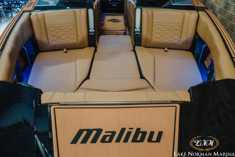 Slide: The Image of 2026 Malibu Wakesetter 23 MXZ interior with tan seating and blue accent lighting. - 5
