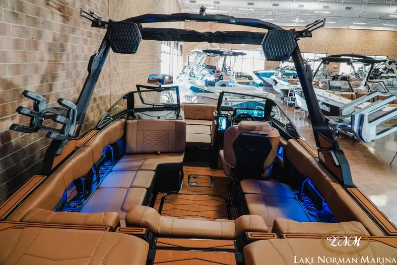 Slide: The Image of 2026 Malibu Wakesetter 23 MXZ interior at Lake Norman Marina, showcasing luxury seating and advanced controls. - 9