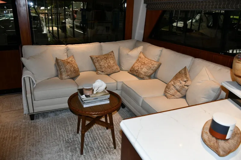 Slide: The Image of Luxurious interior of 1990 Viking 53 Convertible yacht with elegant beige sofa and cushions. - 10