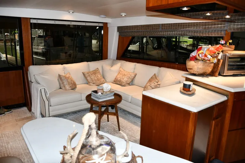 Slide: The Image of Luxurious interior of a 1990 Viking 53 Convertible yacht with cozy seating and elegant decor. - 11