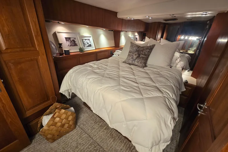 Slide: The Image of Luxurious bedroom interior of 1990 Viking 53 Convertible yacht with cozy bedding and wooden cabinetry. - 17