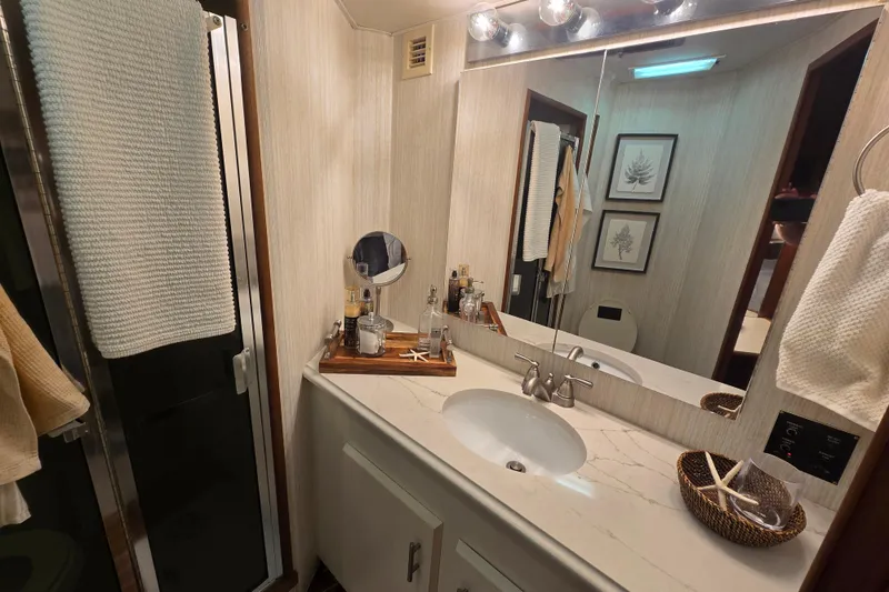 Slide: The Image of Bathroom interior of 1990 Viking 53 Convertible yacht with modern fixtures and decor. - 19