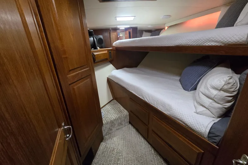 Slide: The Image of Cozy cabin interior of 1990 Viking 53 Convertible yacht with wooden bunk beds. - 20