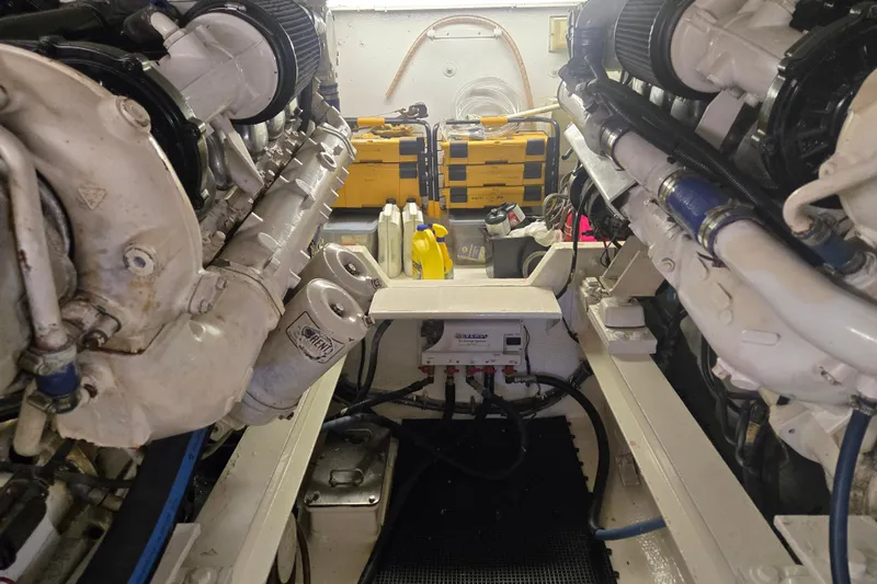 Slide: The Image of Engine room of a 1990 Viking 53 Convertible yacht, showcasing dual engines and equipment. - 27