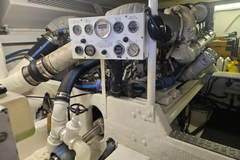 Slide: The Image of Engine room of a 1990 Viking 53 Convertible yacht with control panel and machinery. - 29