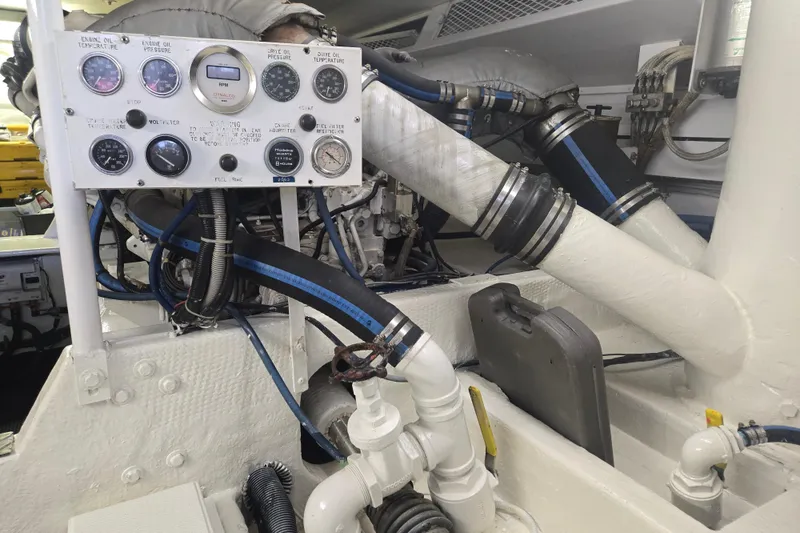 Slide: The Image of Engine room of a 1990 Viking 53 Convertible with gauges and pipes. - 30