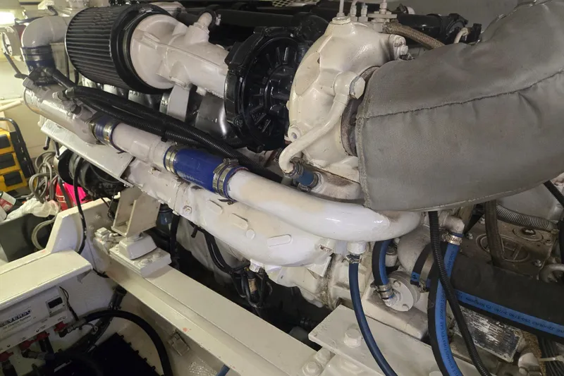 Slide: The Image of Engine room of a 1990 Viking 53 Convertible yacht, showcasing detailed machinery. - 32