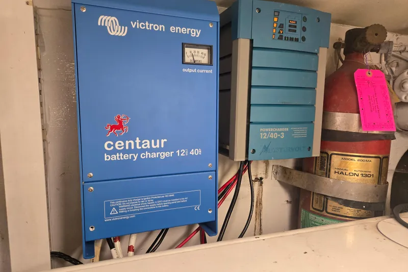 Slide: The Image of Battery chargers and fire extinguisher in 1990 Viking 53 Convertible yacht engine room. - 33