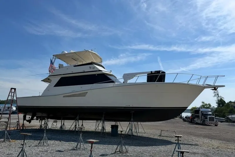 Slide: The Image of 1990 Viking 53 Convertible yacht on stands, clear sky background. - 36