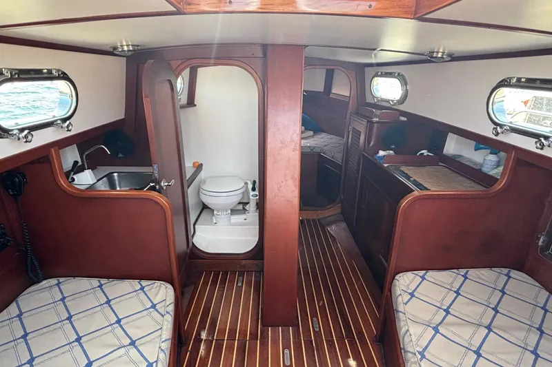 Slide: The Image of Interior of 1998 Hank Hinckley Great Harbor 26 boat with wood finish and compact amenities. - 15