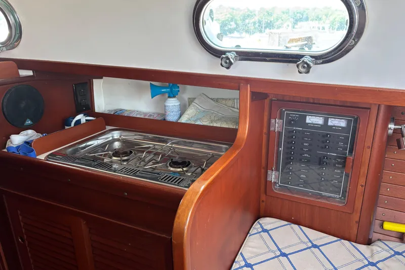 Slide: The Image of Interior of 1998 Hank Hinckley Great Harbor 26 with stove and control panel. - 18
