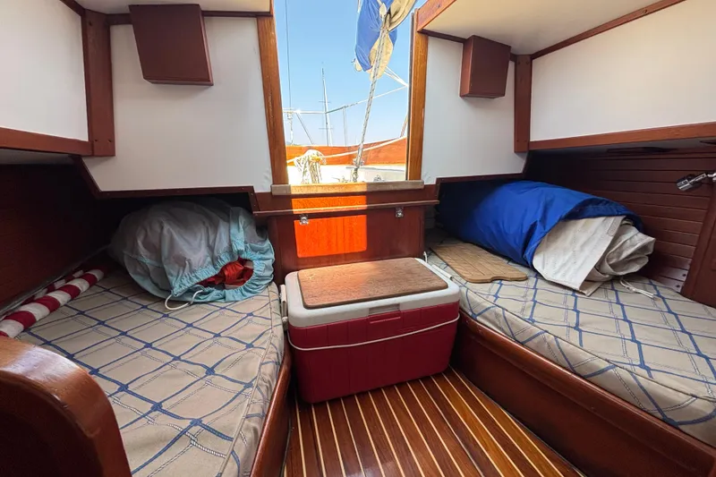 Slide: The Image of Interior of 1998 Hank Hinckley Great Harbor 26 boat with twin beds and wooden accents. - 19