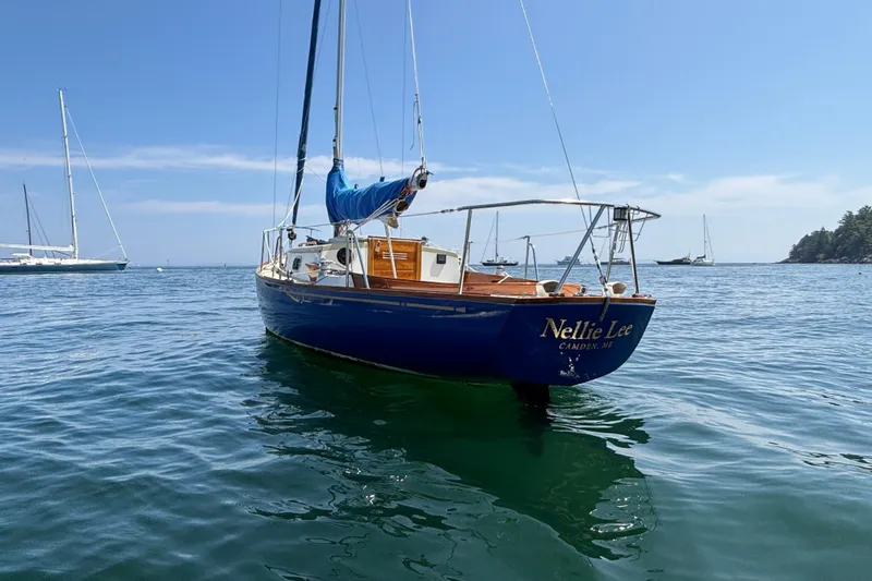 Slide: The Image of 1998 Hank Hinckley Great Harbor 26 sailboat on calm water, blue sky background. - 2