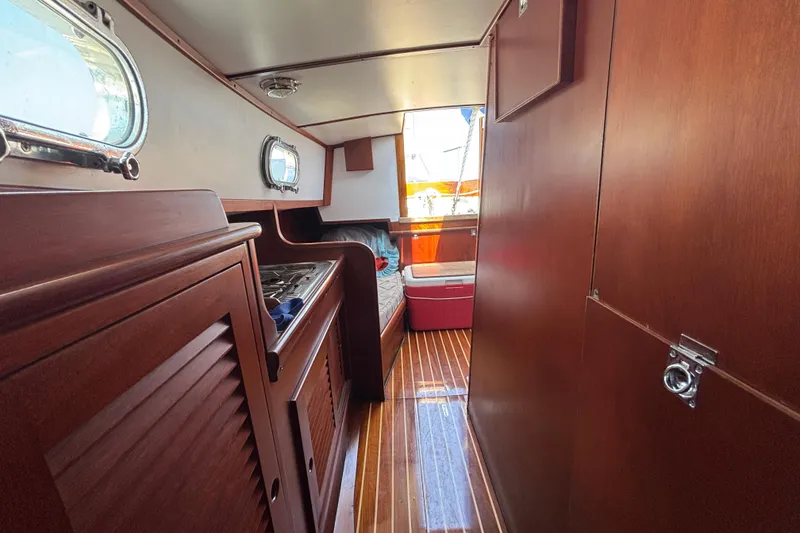 Slide: The Image of Interior of 1998 Hank Hinckley Great Harbor 26 boat with wooden cabinetry and flooring. - 20