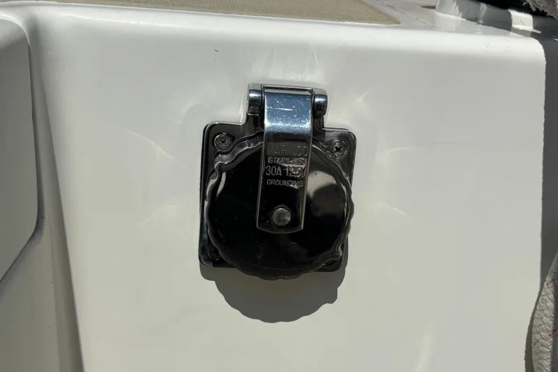 Slide: The Image of Electrical outlet on 1998 Hank Hinckley Great Harbor 26 boat, featuring a chrome cover. - 23