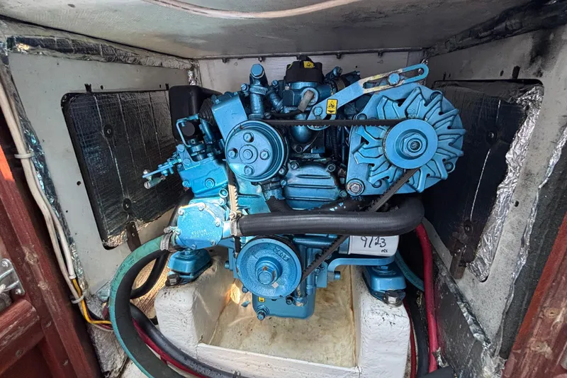 Slide: The Image of Engine compartment of 1998 Hank Hinckley Great Harbor 26 boat, featuring a blue marine engine. - 24