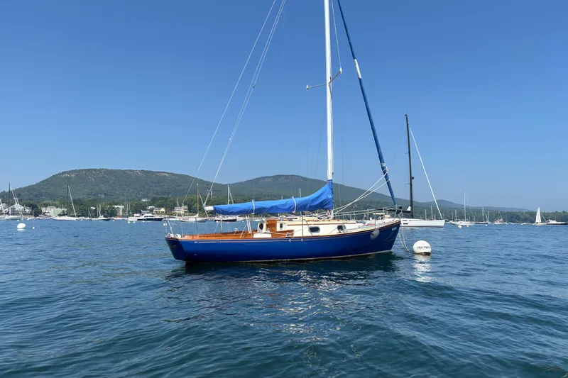 Slide: The Image of Sailboat "Hank Hinckley Great Harbor 26" from 1998 on calm water, scenic background. - 3