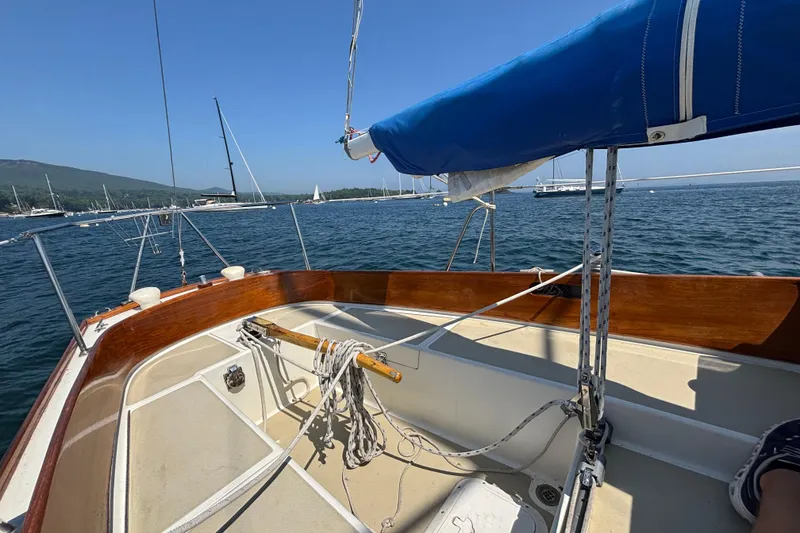 Slide: The Image of 1998 Hank Hinckley Great Harbor 26 sailboat on calm waters, blue sky, and distant hills. - 8