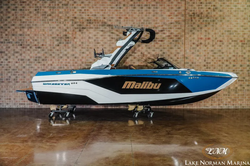 The Image of 2026 Malibu Wakesetter 21 LX boat displayed indoors at Lake Norman Marina. - 1