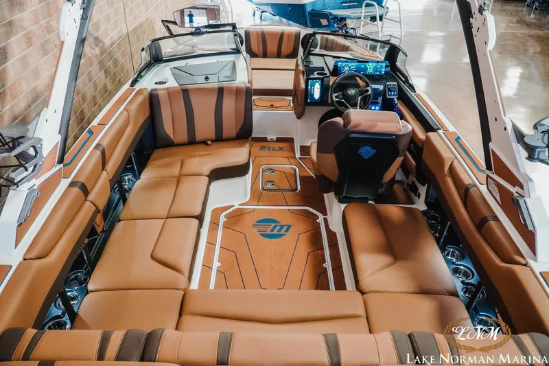 Slide: The Image of 2026 Malibu Wakesetter 21 LX interior with luxurious brown seating and modern dashboard. - 10