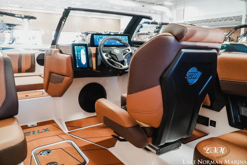 Slide: The Image of 2026 Malibu Wakesetter 21 LX interior with modern dashboard and luxurious seating at Lake Norman Marina. - 12
