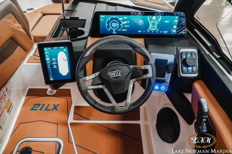 Slide: The Image of 2026 Malibu Wakesetter 21 LX dashboard with advanced digital controls and steering wheel. - 14