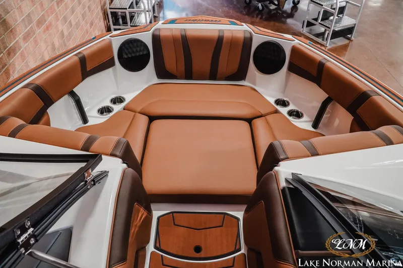 Slide: The Image of 2026 Malibu Wakesetter 21 LX interior with brown leather seating and cup holders. - 16