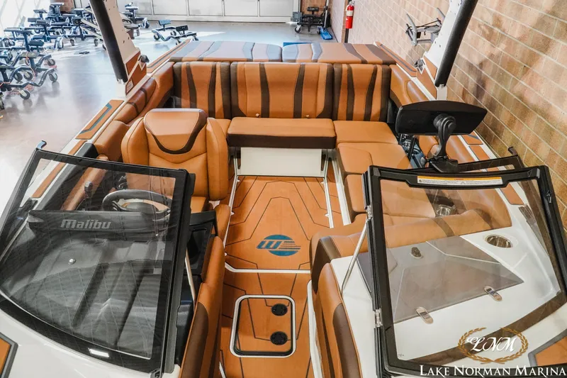 Slide: The Image of 2026 Malibu Wakesetter 21 LX interior with luxurious tan seating and modern dashboard. - 17