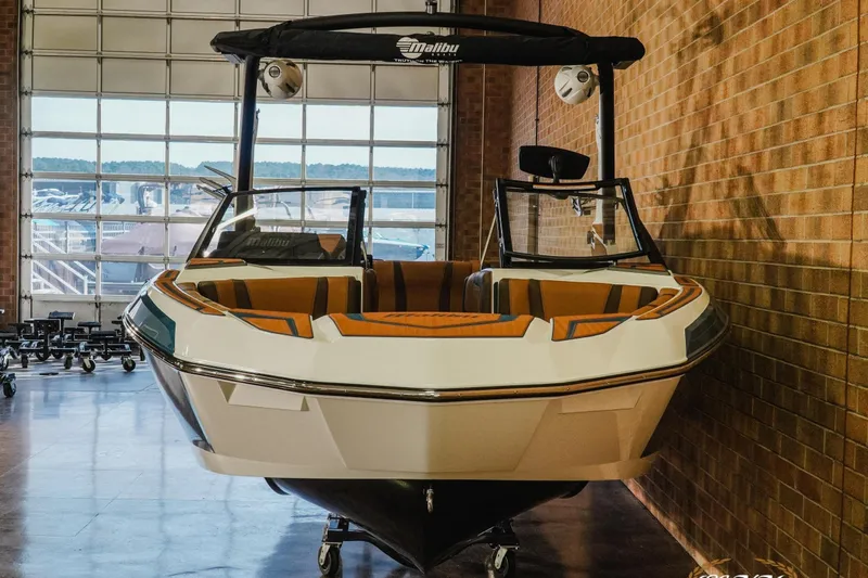 Slide: The Image of 2026 Malibu Wakesetter 21 LX boat in showroom, featuring sleek design and modern interior. - 4