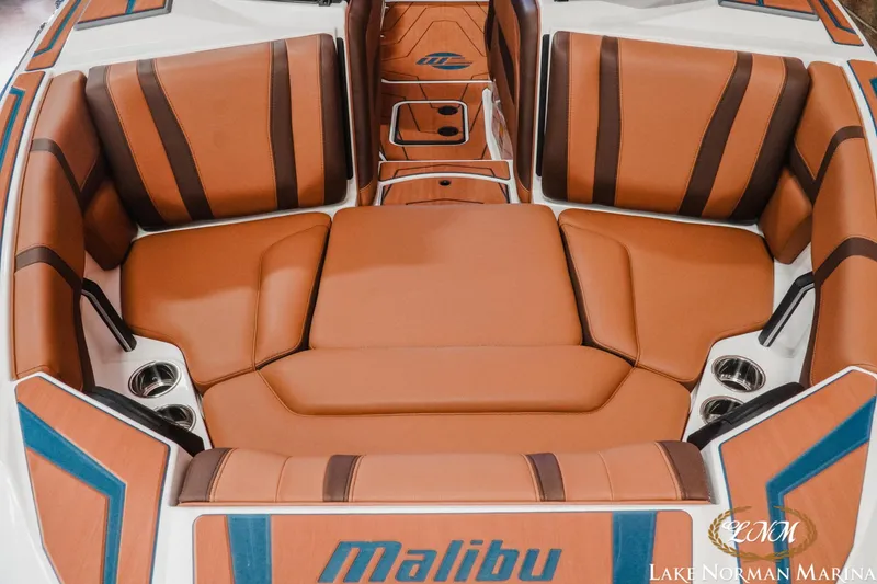 Slide: The Image of 2026 Malibu Wakesetter 21 LX boat interior with luxurious brown seating and cup holders. - 5