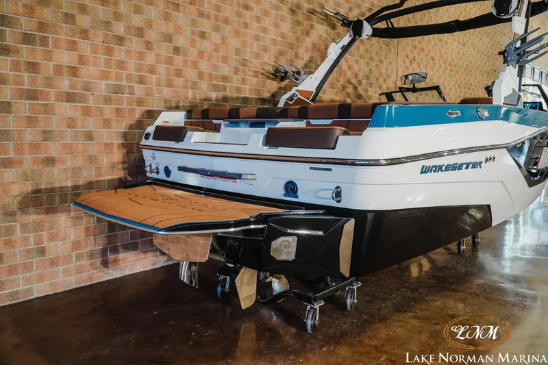 Slide: The Image of 2026 Malibu Wakesetter 21 LX boat in showroom, featuring sleek design and modern features. - 7