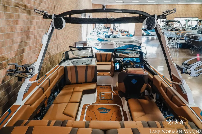 Slide: The Image of 2026 Malibu Wakesetter 21 LX interior at Lake Norman Marina, showcasing luxury seating and advanced controls. - 9