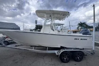 The Image of 2025 Sea Born LX22 Center Console boat on trailer, parked outdoors. - 0