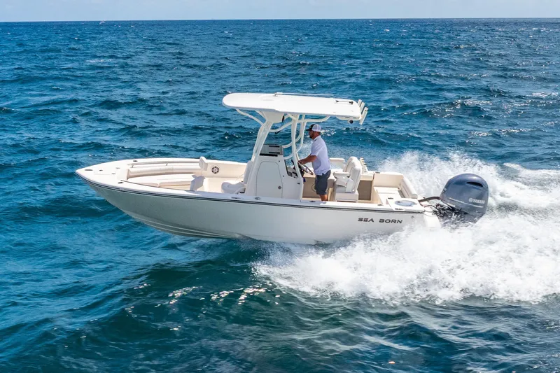 Slide: The Image of 2025 Sea Born LX22 Center Console boat cruising on open ocean waters. - 14