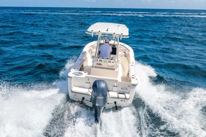 Slide: The Image of 2025 Sea Born LX22 Center Console boat cruising on open ocean waters. - 17