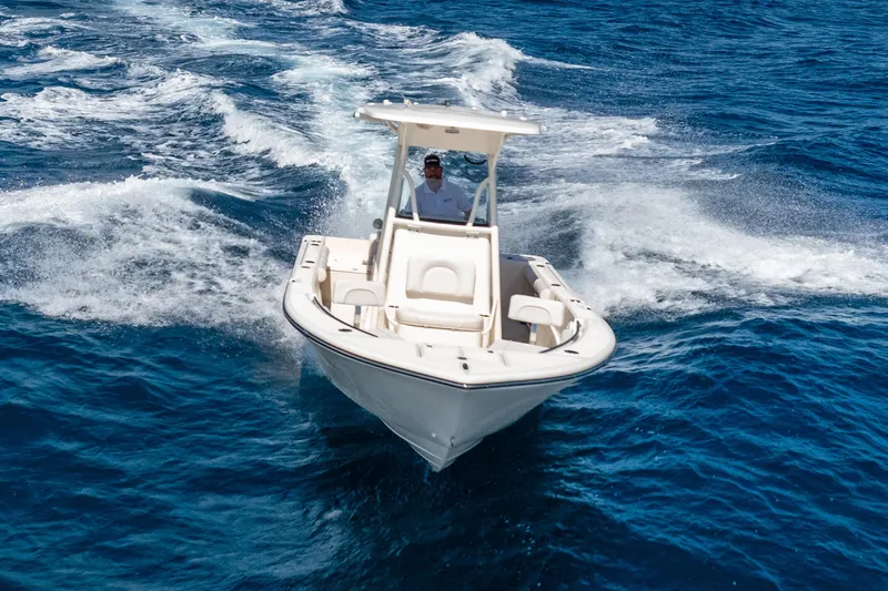 Slide: The Image of 2025 Sea Born LX22 Center Console boat cruising on open blue water. - 18