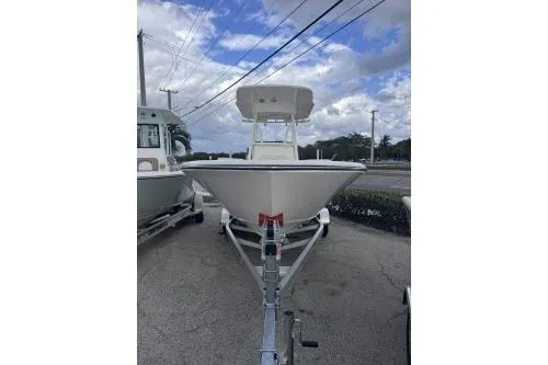 Slide: The Image of 2025 Sea Born LX22 Center Console boat on trailer, parked outdoors under cloudy sky. - 2