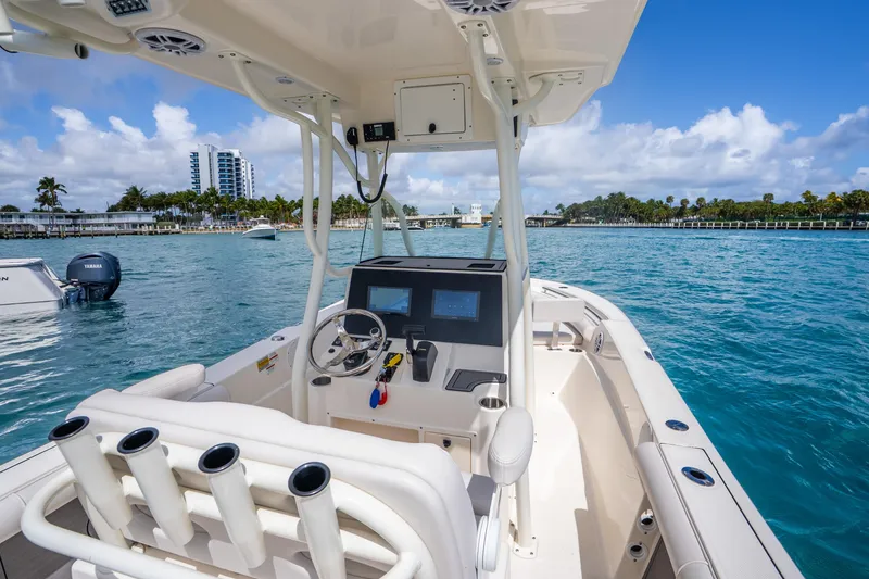 Slide: The Image of 2025 Sea Born LX22 Center Console boat on clear blue water, featuring modern controls. - 22