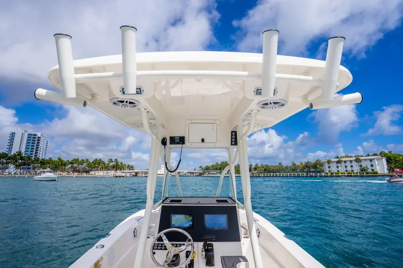 Slide: The Image of 2025 Sea Born LX22 Center Console boat on blue water under a clear sky. - 23