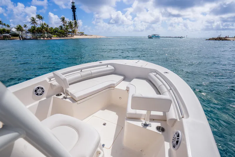 Slide: The Image of 2025 Sea Born LX22 Center Console boat on clear blue water near a lighthouse. - 28