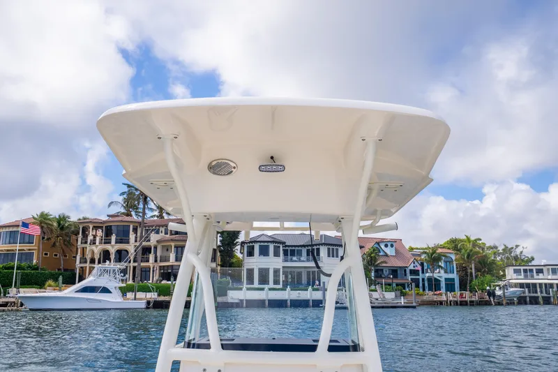Slide: The Image of 2025 Sea Born LX22 Center Console boat on water, with waterfront homes in the background. - 32