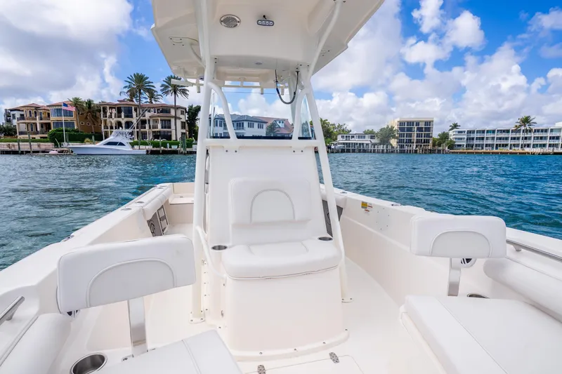 Slide: The Image of 2025 Sea Born LX22 Center Console boat on water, with luxury waterfront homes in background. - 33