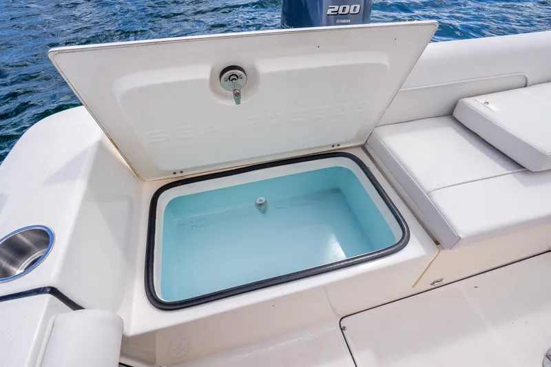 Slide: The Image of 2025 Sea Born LX22 Center Console boat with open storage compartment on deck. - 34