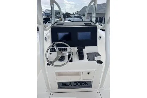 Slide: The Image of 2025 Sea Born LX22 Center Console boat dashboard with dual screens and steering wheel. - 4
