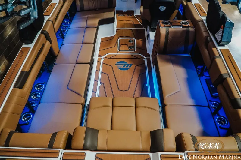 Slide: The Image of 2026 Malibu Wakesetter 25 LSV interior with luxurious seating and ambient blue lighting. - 10