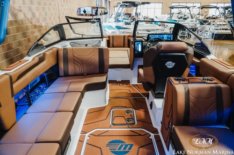 Slide: The Image of 2026 Malibu Wakesetter 25 LSV interior with luxurious seating and modern dashboard. - 11