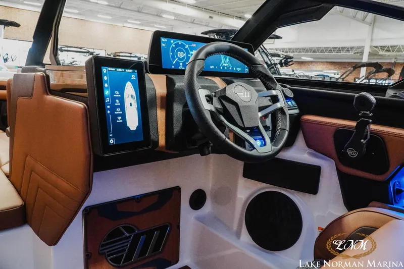 Slide: The Image of 2026 Malibu Wakesetter 25 LSV boat interior with advanced digital dashboard and steering wheel. - 16