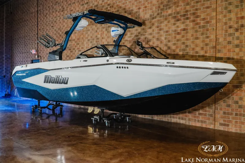 Slide: The Image of 2026 Malibu Wakesetter 25 LSV boat displayed indoors at Lake Norman Marina. - 2