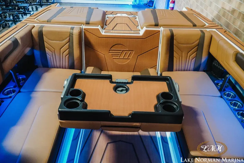 Slide: The Image of 2026 Malibu Wakesetter 25 LSV interior with luxurious seating and cup holders. - 22